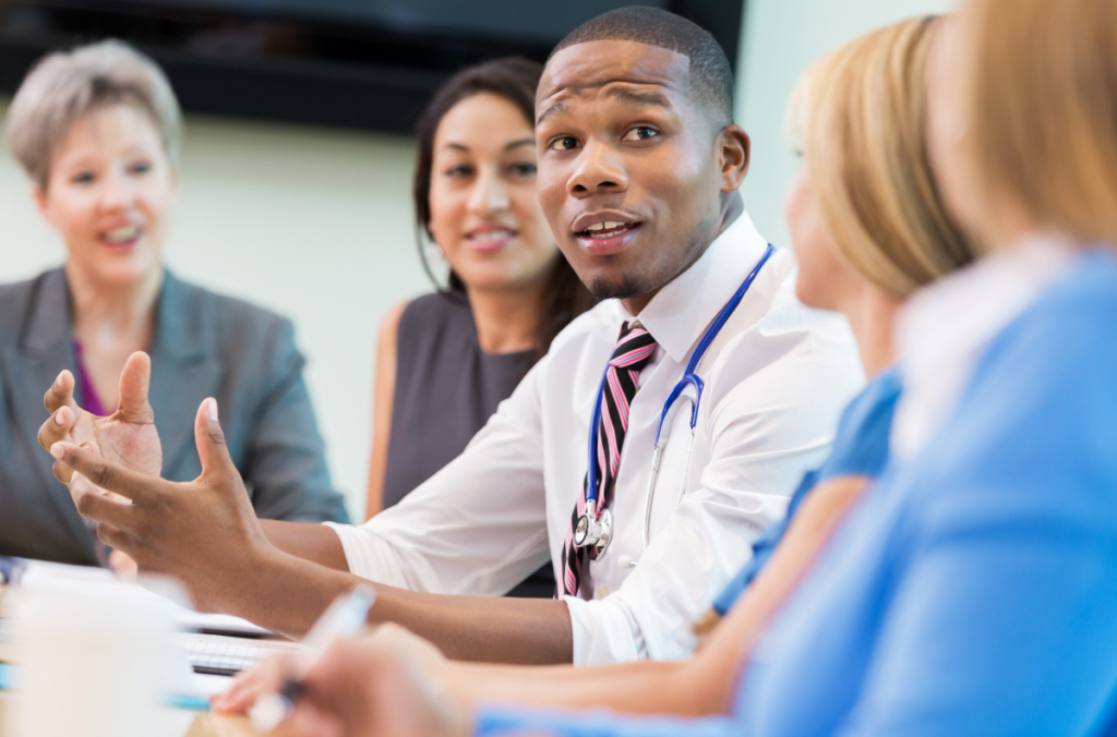 A male doctor in a meeting with our clinical staff